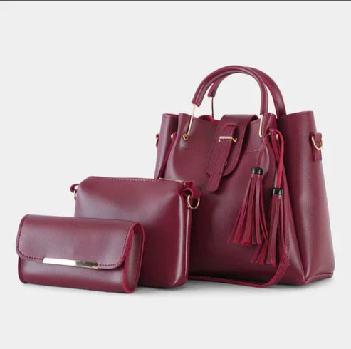 Women's handbag bundle featuring a structured tote, crossbody bag, and wallet in deep burgundy.